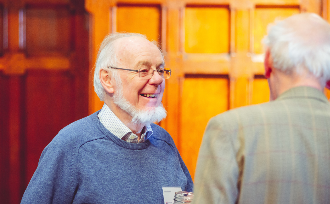 Two retired staff association members socialising.