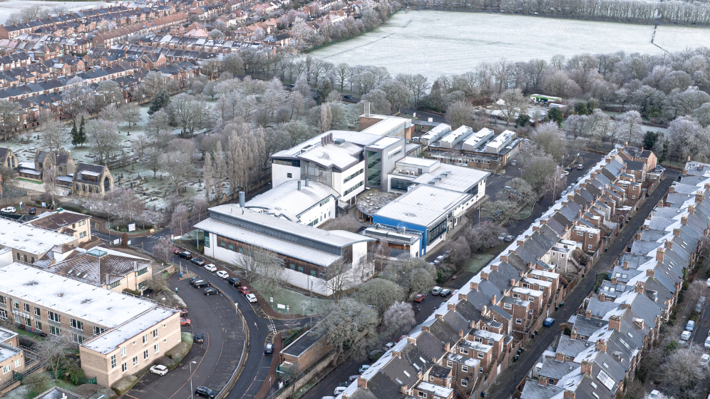 A view of the current site from above. The view is take from the Westgate Road side of the site, and the current site buildings can be seen alongside the terrace housing on the right. In the distance, the town moor can be seen. 