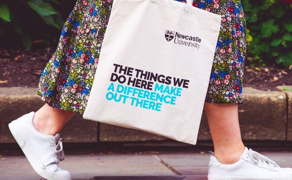 A photo showing a women walking through the University