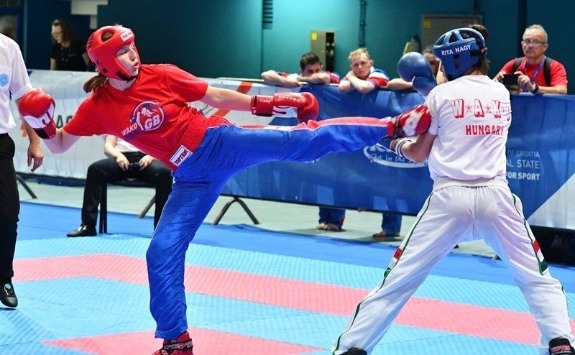 Student Nesta Baxter kicking an opponent in the WAKO Kickboxing event.