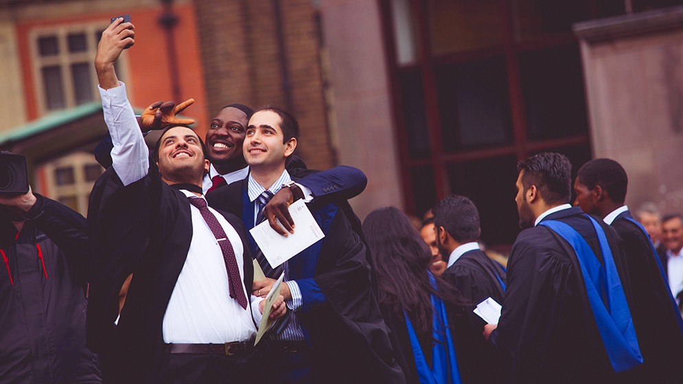 Newcastle students celebrating at graduation.