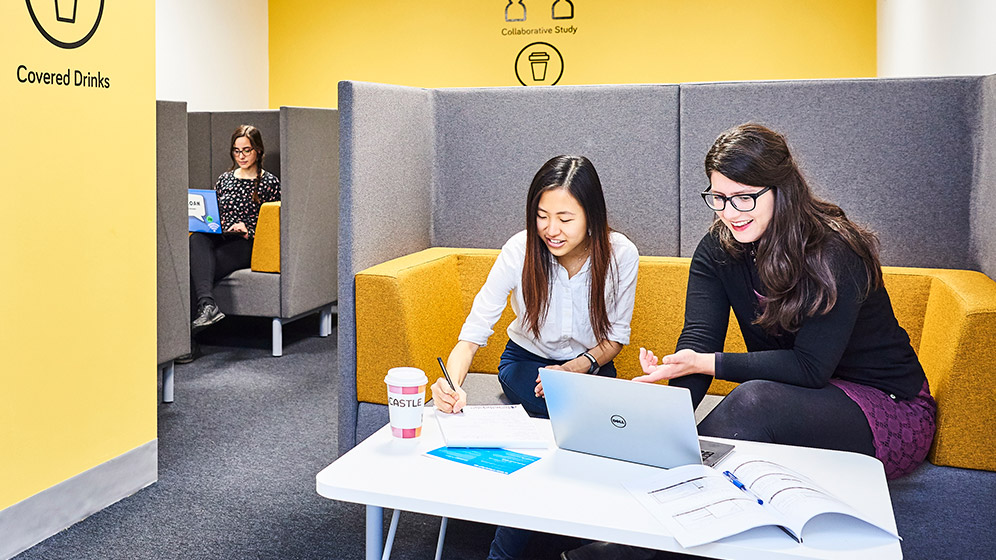 Students chatting at a work station